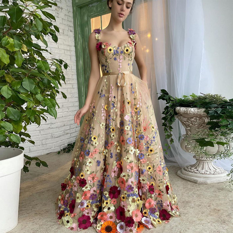 The Bloom Gown by Marlowe House. Hand-placed 3D floral embroidery across sheer tulle, a sweetheart neckline, and a silhouette built.