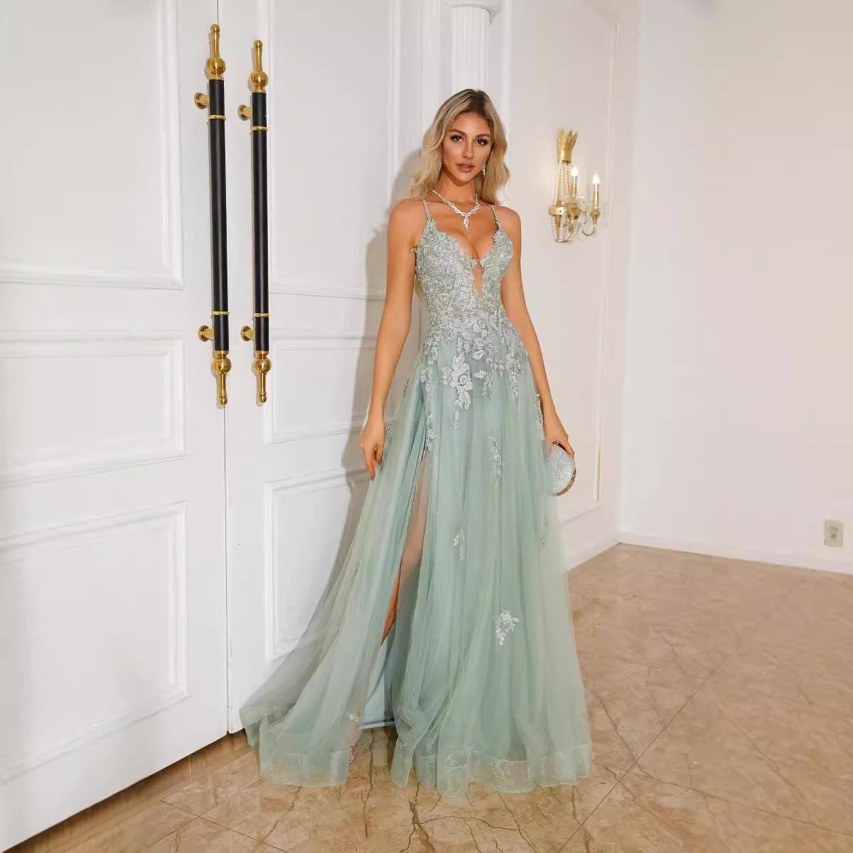 The Suspender Gown (Lace) by Marlowe House. Hand-appliquéd lace bodice, a plunging neckline, a slit that moves with every step, and a tulle.